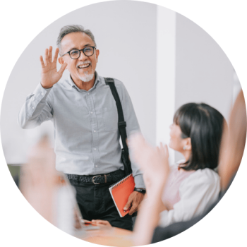 Older man waving at coworker